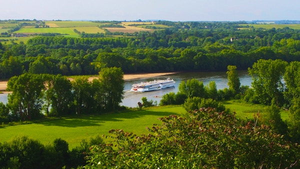 Skipet MS Loire Princesse på elven i den grønne, frodige Loiredalen med åkre i bakgrunnen