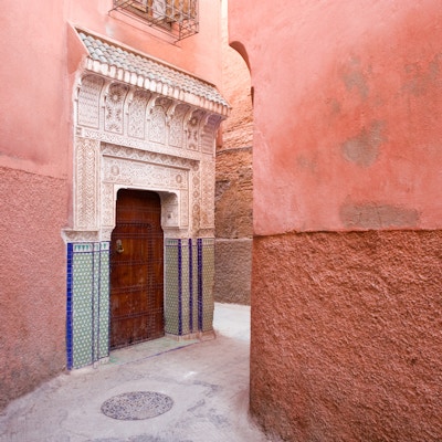 Vakker marokkansk dør dekorert av utskårne stukkatur i en skjult bakgate i den gamle Medina i Marrakesh, Marokko.