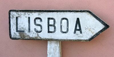 Tradisjonell skiltpost til Lisboa eller Lisboa. Hvitt skilt med svarte bokstaver mot en rosa vegg. Cascais, Portugal.