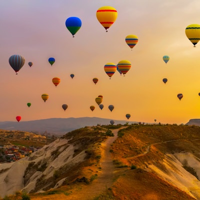 Luftballonger som lander i et fjell Cappadocia Goreme nasjonalpark, Tyrkia.