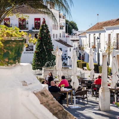 Mijas, Spania - 5. januar 2014: Turister som sitter i en fortauskafé i sentrale gaten i Mijas. Mijas er en nydelig andalusisk hvit landsby på Costa del Sol. Populære turistmål, mest elskede sted av mennesker