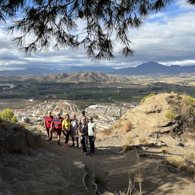 Gruppe mennesker avbildet foran et utsiktspunkt i fjellet